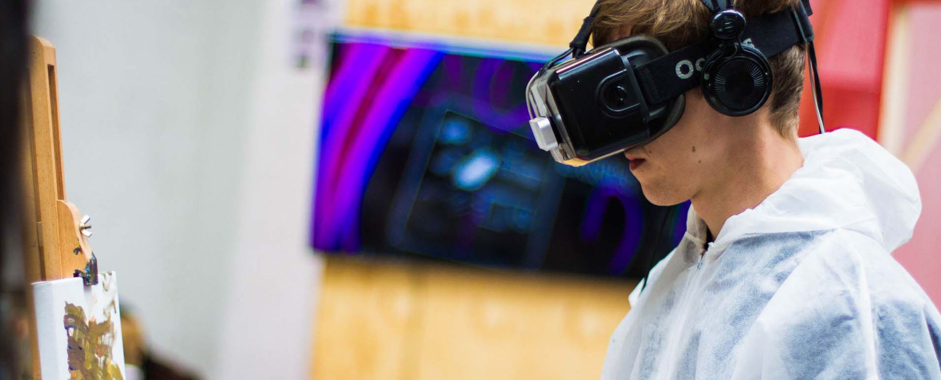 Person wearing VR headset and painting
